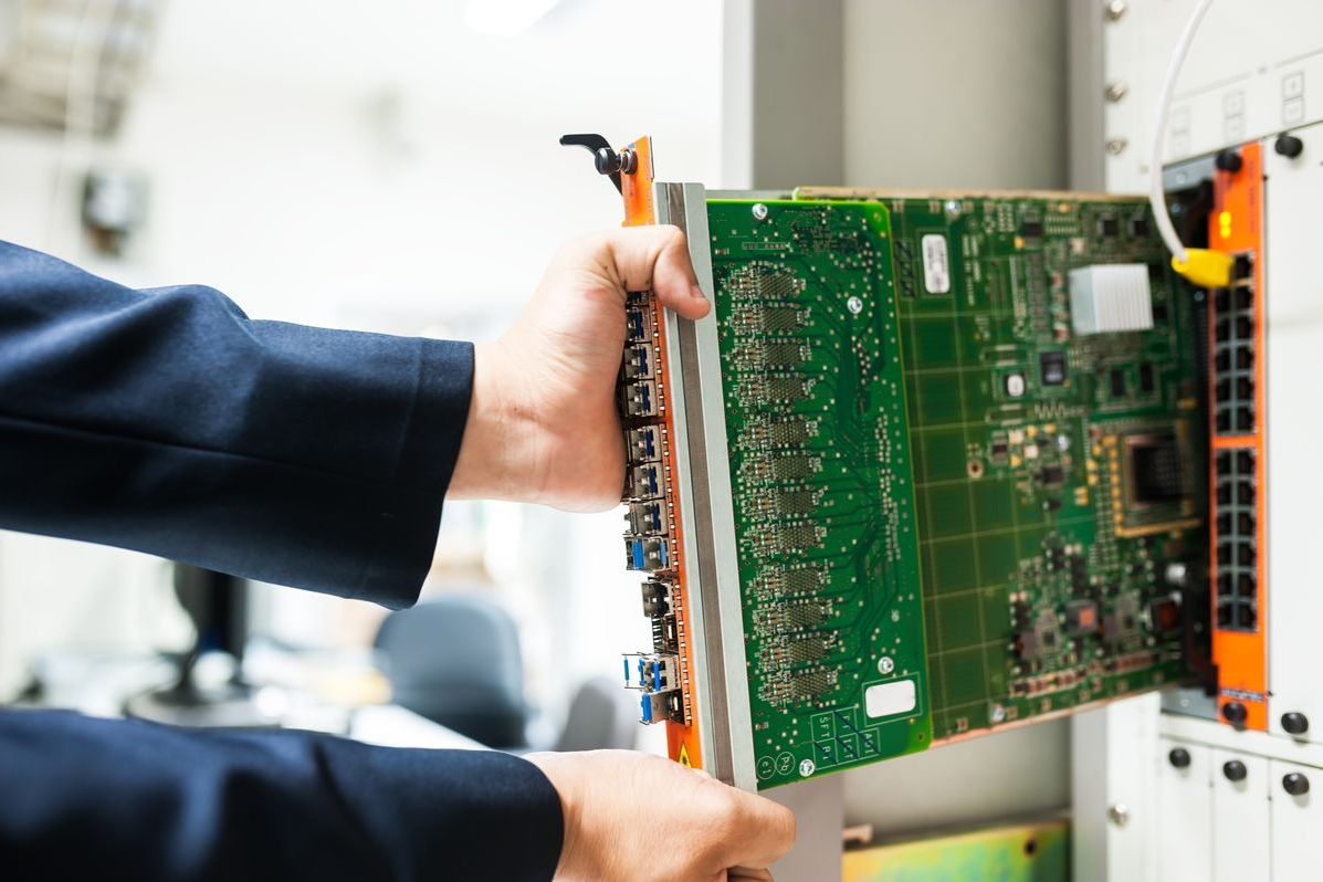 Technician replacing a line card in an equipment chassis